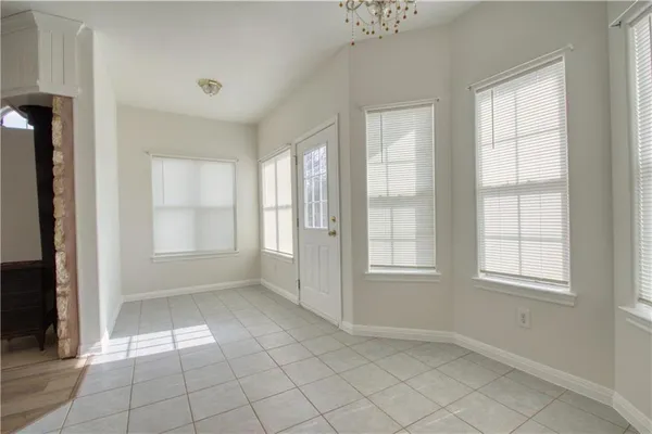 an empty room with windows and closet