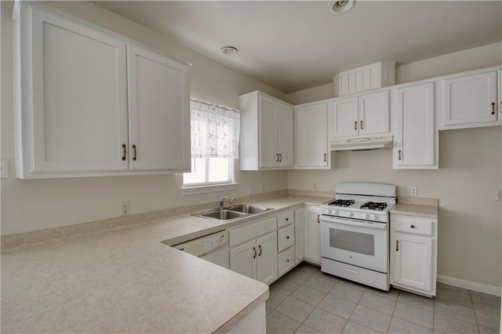 1770 County Road 329 Granger, TX 76530 - Photo 10 of 23 a kitchen with white cabinets stainless steel appliances and sink
