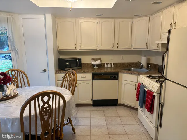 a kitchen with a stove a sink and a refrigerator