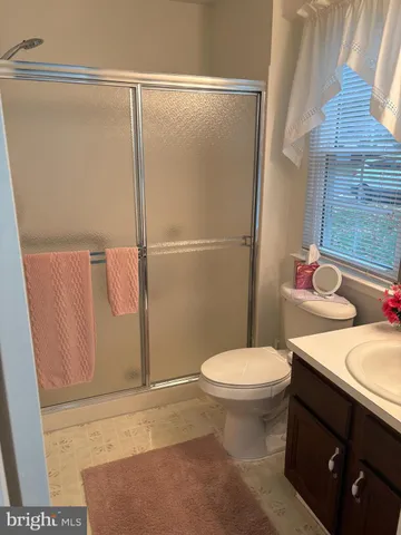 a white toilet sitting next to a bathroom sink