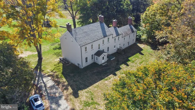 a view of a livingroom with wooden floor and a fireplace