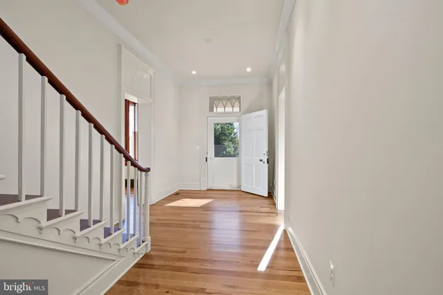 a view of an empty room with a fireplace and a window
