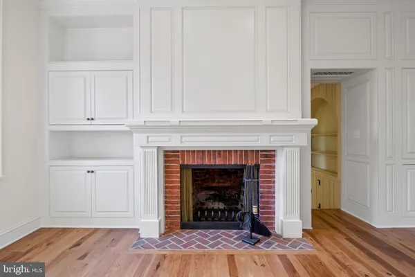 a kitchen with white cabinets and appliances