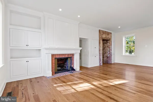 a kitchen with granite countertop white cabinets and a window