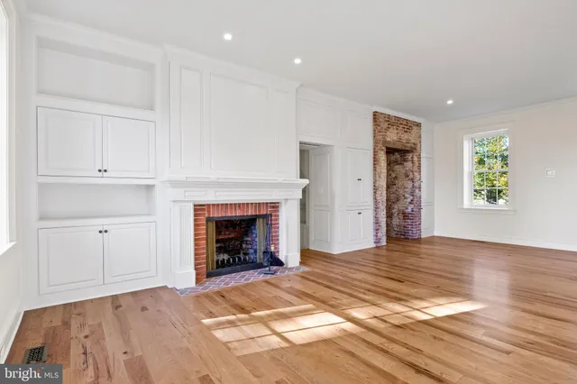 a kitchen with granite countertop white cabinets and a window