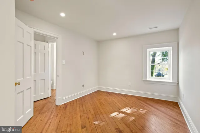 a view of a hallway with windows and stairs