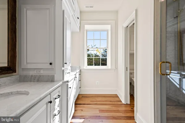 a view of a house with a big yard and large trees
