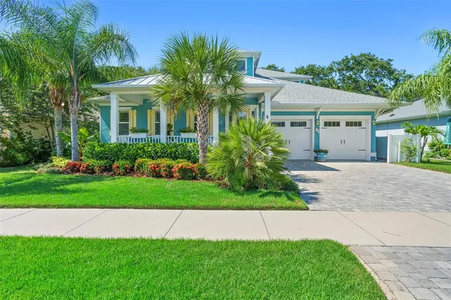 a front view of a house with a garden and plants