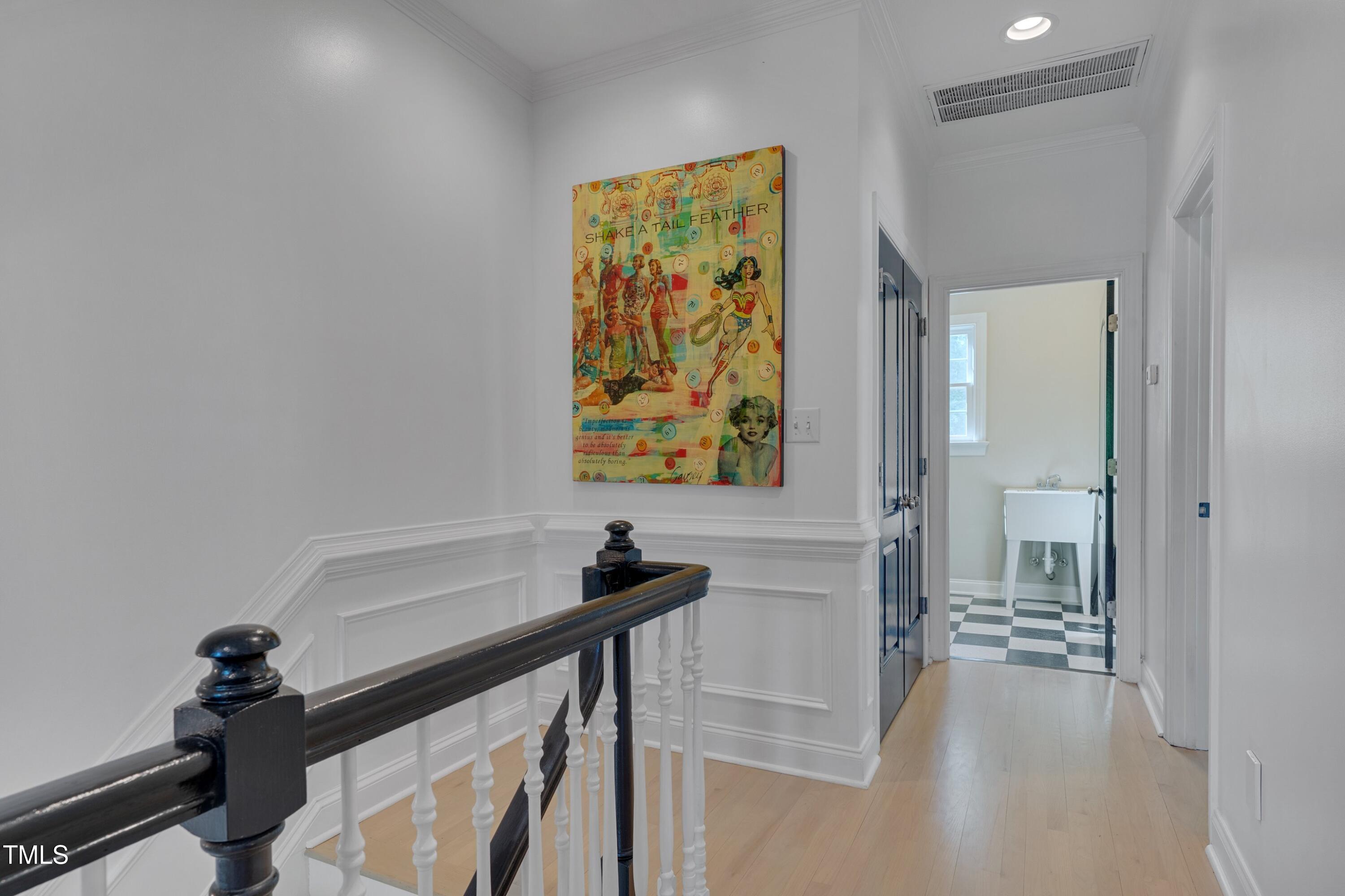 2306 Byrd Street Raleigh, NC 27608 - Photo 37 of 60 a view of a hallway with paintings on the wall