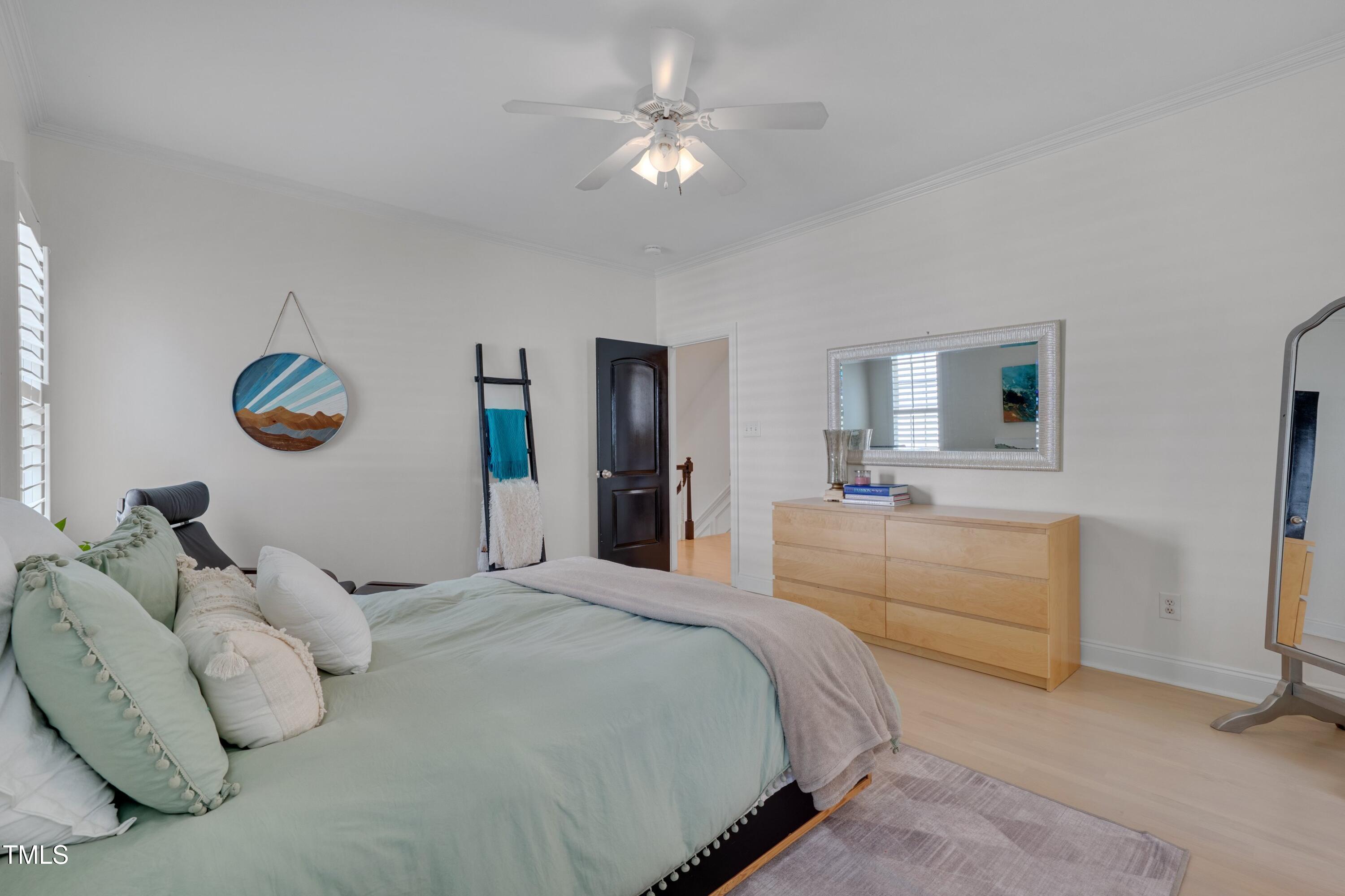 2306 Byrd Street Raleigh, NC 27608 - Photo 40 of 60 a bedroom with a large bed and a chandelier