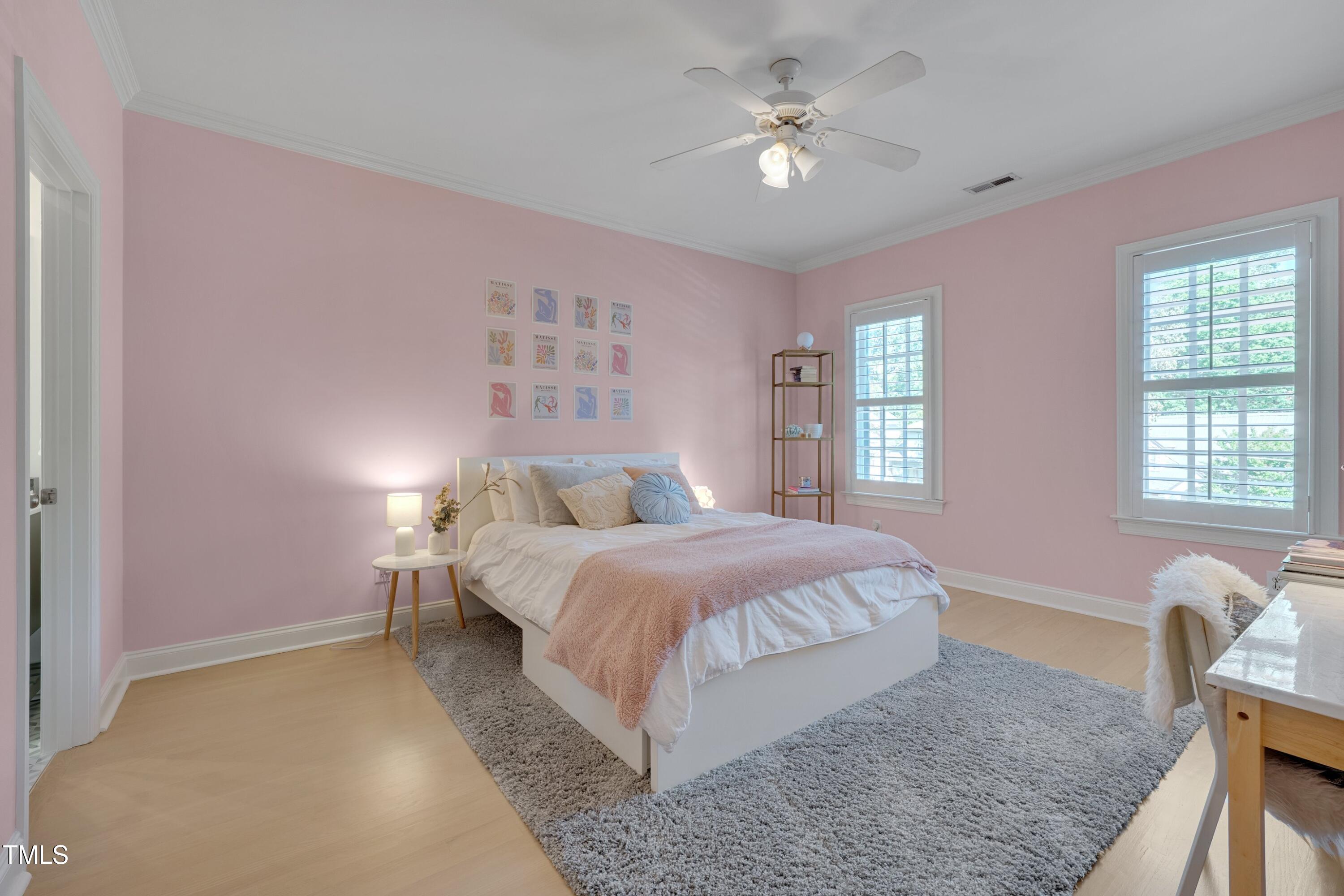 2306 Byrd Street Raleigh, NC 27608 - Photo 42 of 60 a bedroom with a large bed and a chandelier