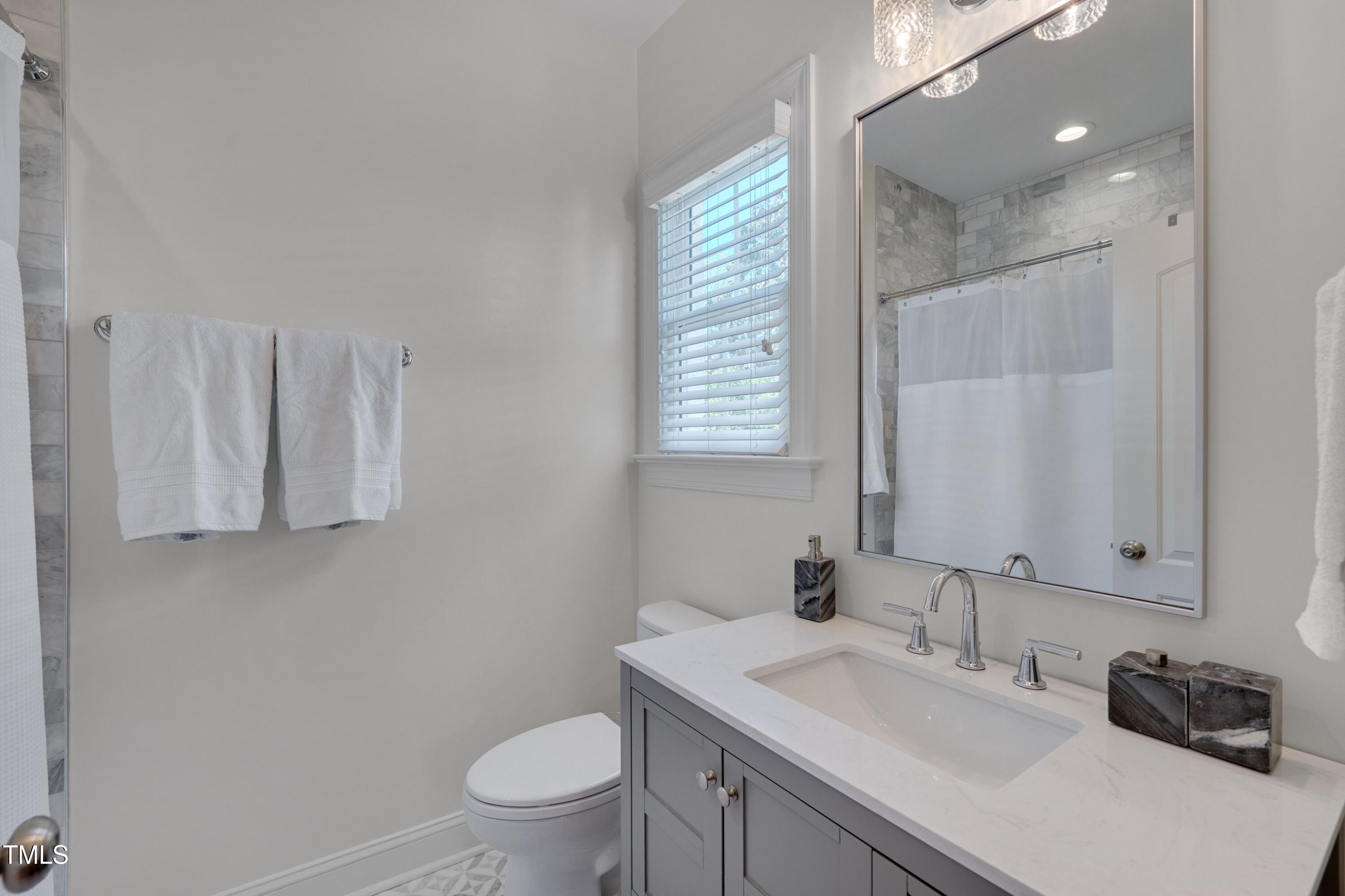 2306 Byrd Street Raleigh, NC 27608 - Photo 43 of 60 a bathroom with a granite countertop sink toilet and mirror