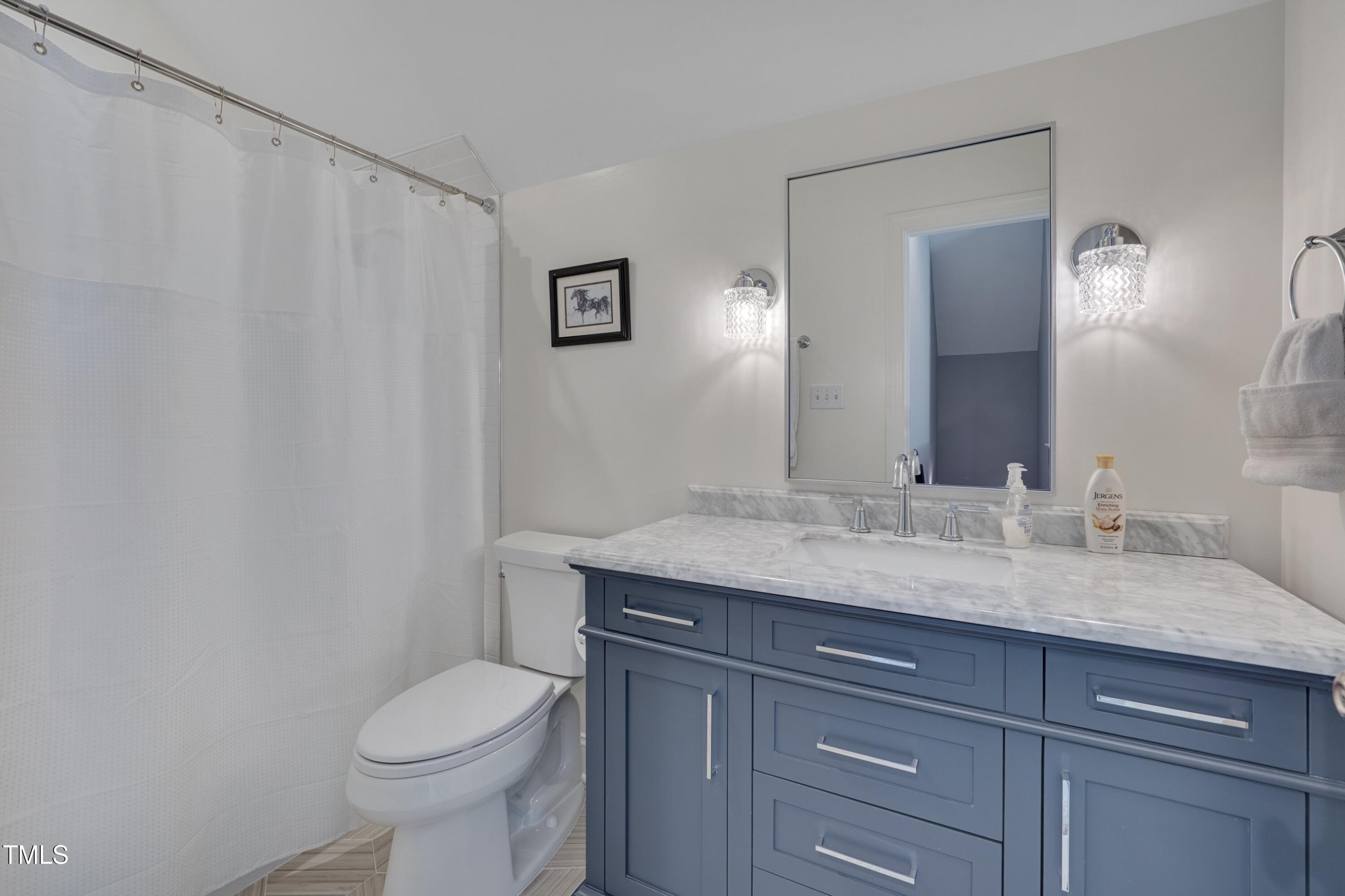 2306 Byrd Street Raleigh, NC 27608 - Photo 47 of 60 a bathroom with a granite countertop sink toilet and mirror