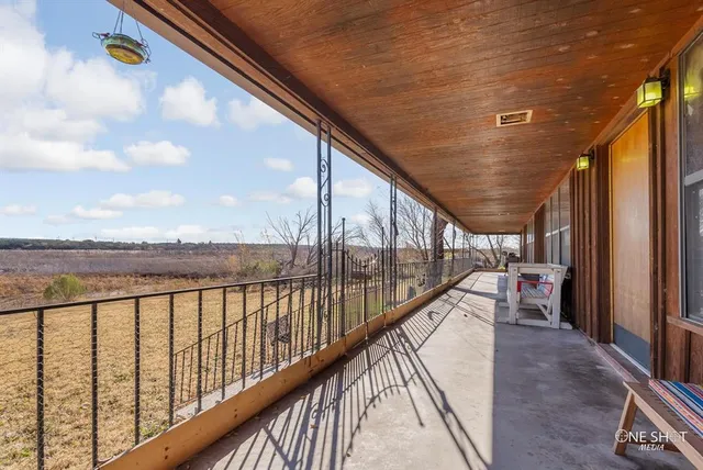 a balcony view with a seating space