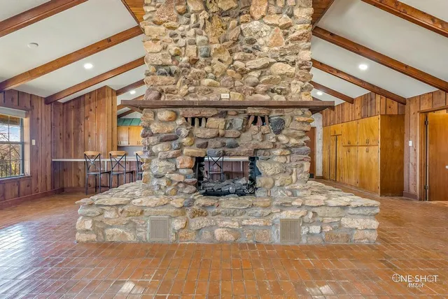 a living room with fireplace furniture and a chandelier
