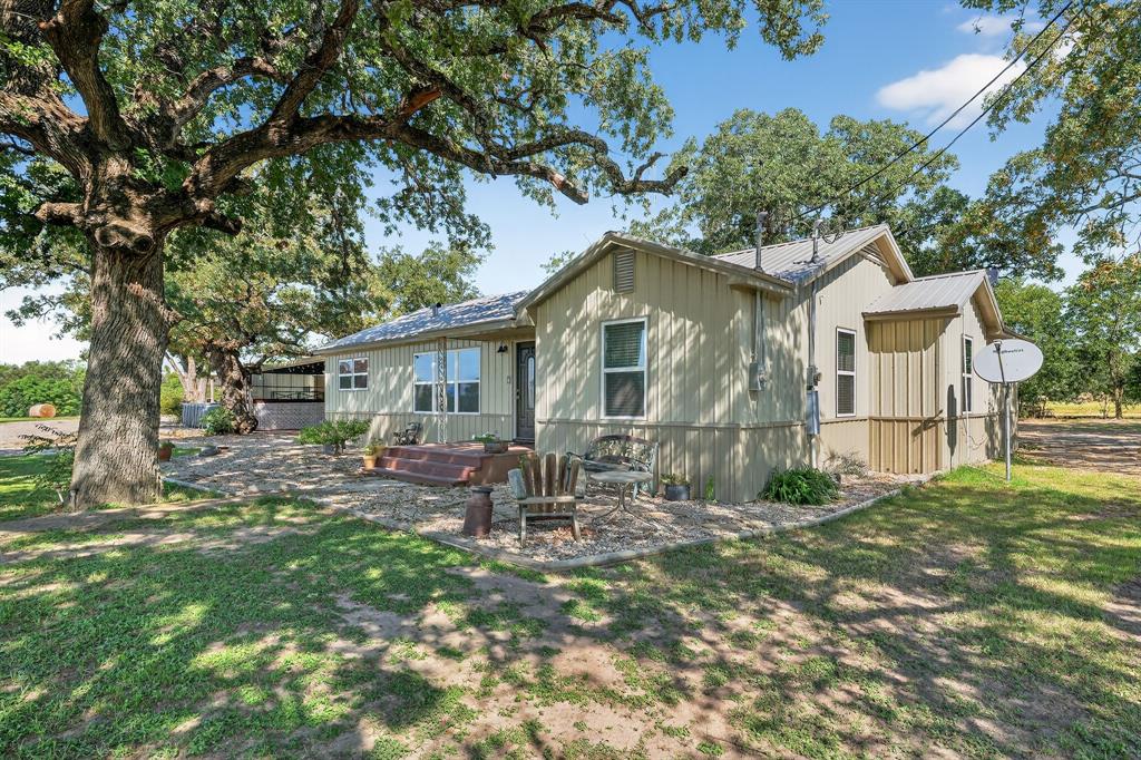5485 Highway 7 Marlin, TX 76661 - Photo 36 of 36 Back of property featuring a patio, a lawn, and a metal roof