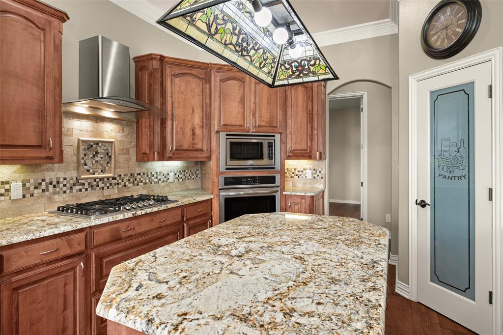 167 Duke Trail Weatherford, TX 76088 - Photo 11 of 40 a large kitchen with stainless steel appliances granite countertop a stove and a wooden cabinets