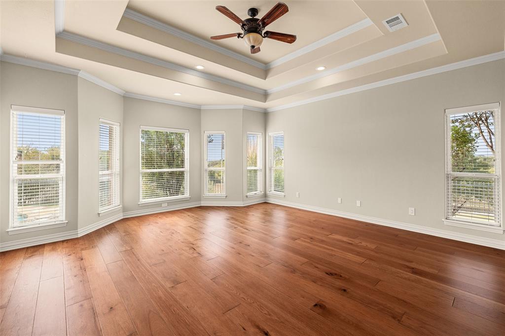 167 Duke Trail Weatherford, TX 76088 - Photo 16 of 40 a view of an empty room with wooden floor and a window