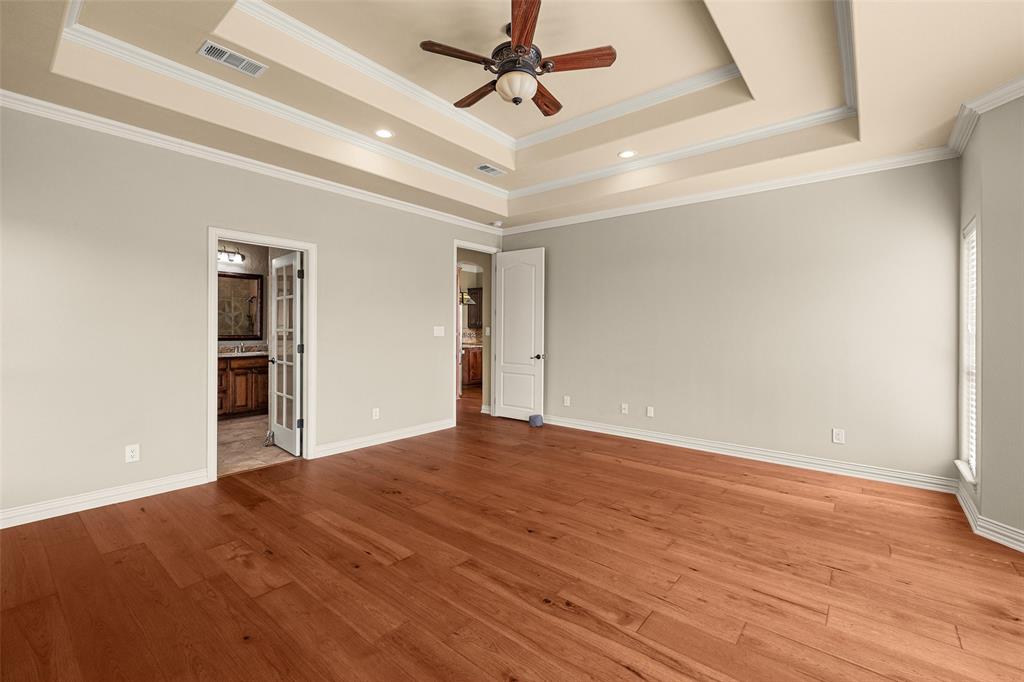 167 Duke Trail Weatherford, TX 76088 - Photo 17 of 40 a view of empty room with wooden floor and ceiling fan
