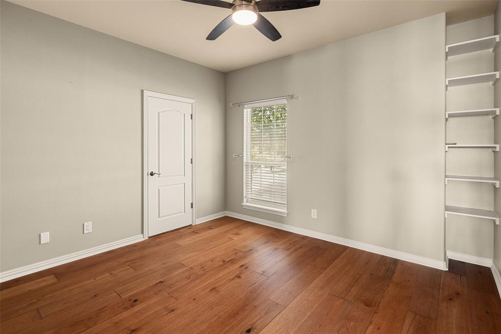 167 Duke Trail Weatherford, TX 76088 - Photo 22 of 40 an empty room with wooden floor and a ceiling fan