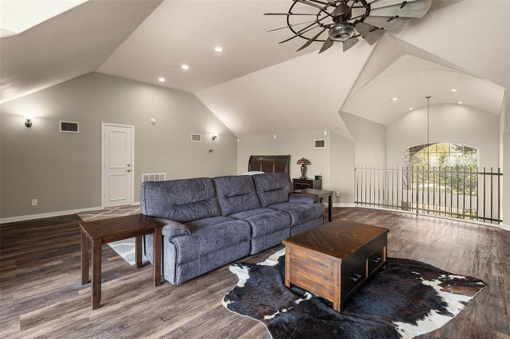 167 Duke Trail Weatherford, TX 76088 - Photo 27 of 40 a living room with furniture a wooden floor and a chandelier