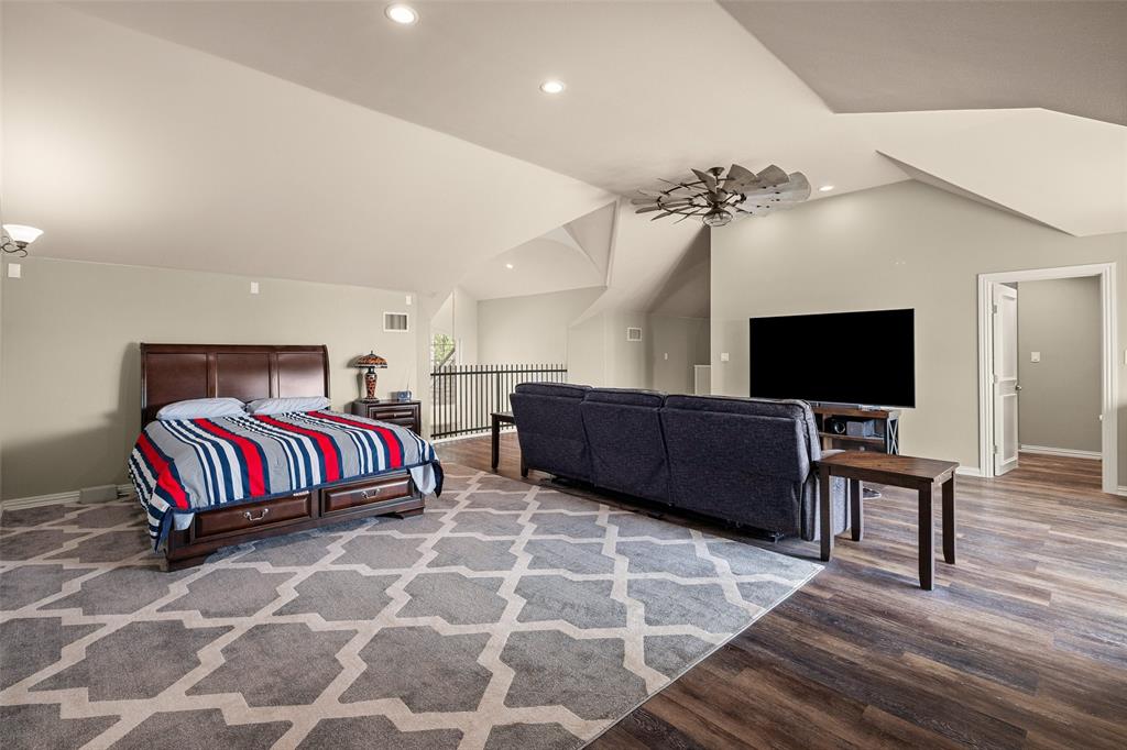 167 Duke Trail Weatherford, TX 76088 - Photo 28 of 40 a living room with a bed and a flat screen tv