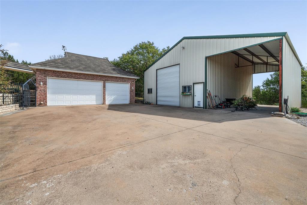 167 Duke Trail Weatherford, TX 76088 - Photo 36 of 40 a view of a house with a yard and garage