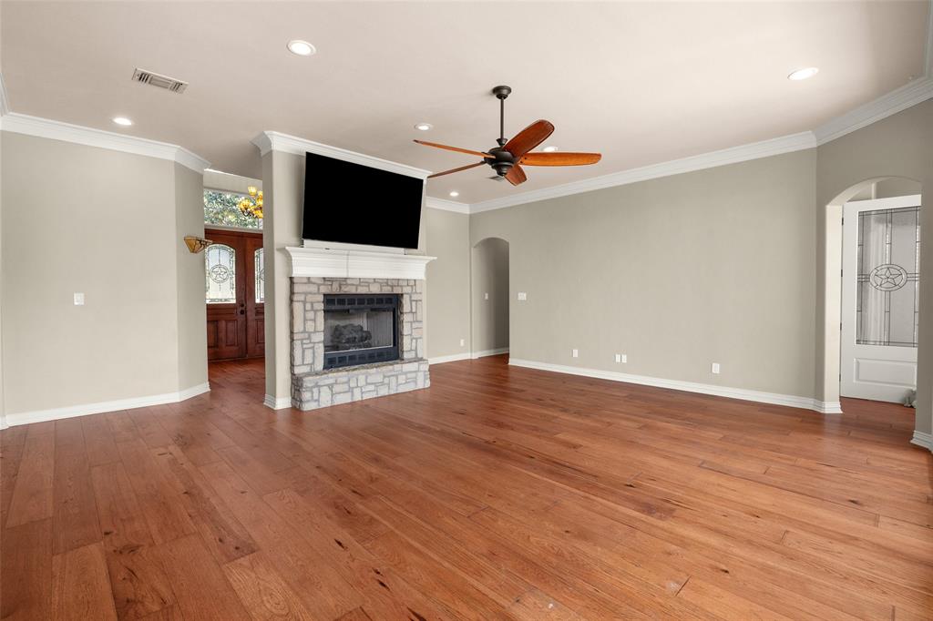 167 Duke Trail Weatherford, TX 76088 - Photo 6 of 40 a view of a livingroom with a flat screen tv and fireplace