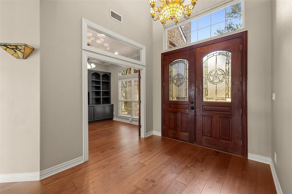 167 Duke Trail Weatherford, TX 76088 - Photo 8 of 40 wooden floor with a chandelier in a room
