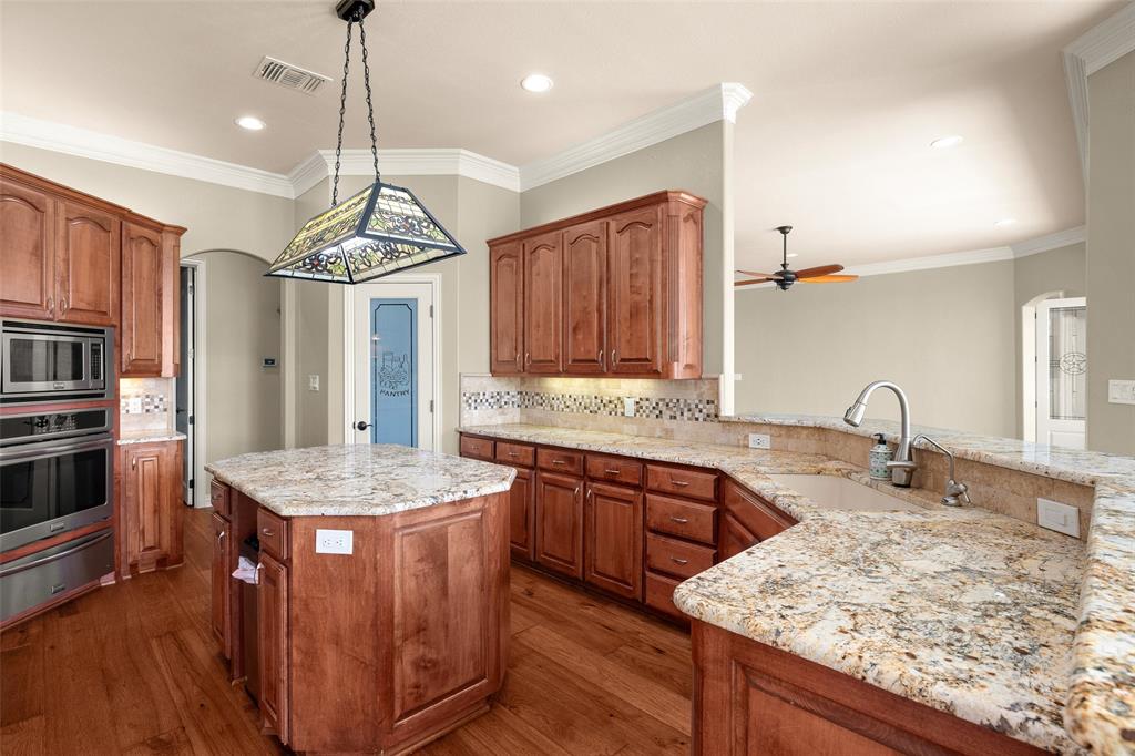 167 Duke Trail Weatherford, TX 76088 - Photo 10 of 40 a kitchen with stainless steel appliances granite countertop a sink stove and refrigerator