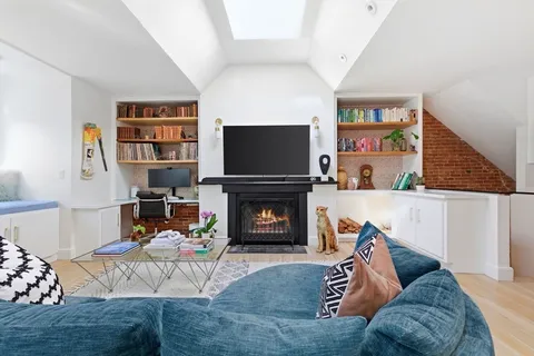 a kitchen view with wooden floor and cabinets