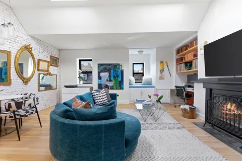 a bedroom with furniture and a flat screen tv