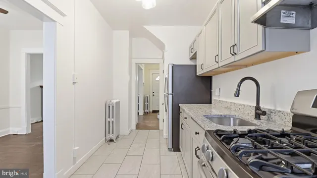 a kitchen with stainless steel appliances granite countertop a stove and a sink
