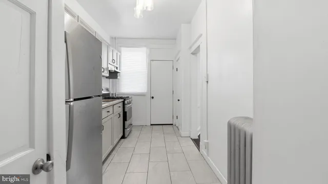 a kitchen with a refrigerator and a stove
