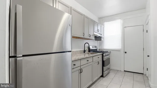 a kitchen with appliances cabinets and a window