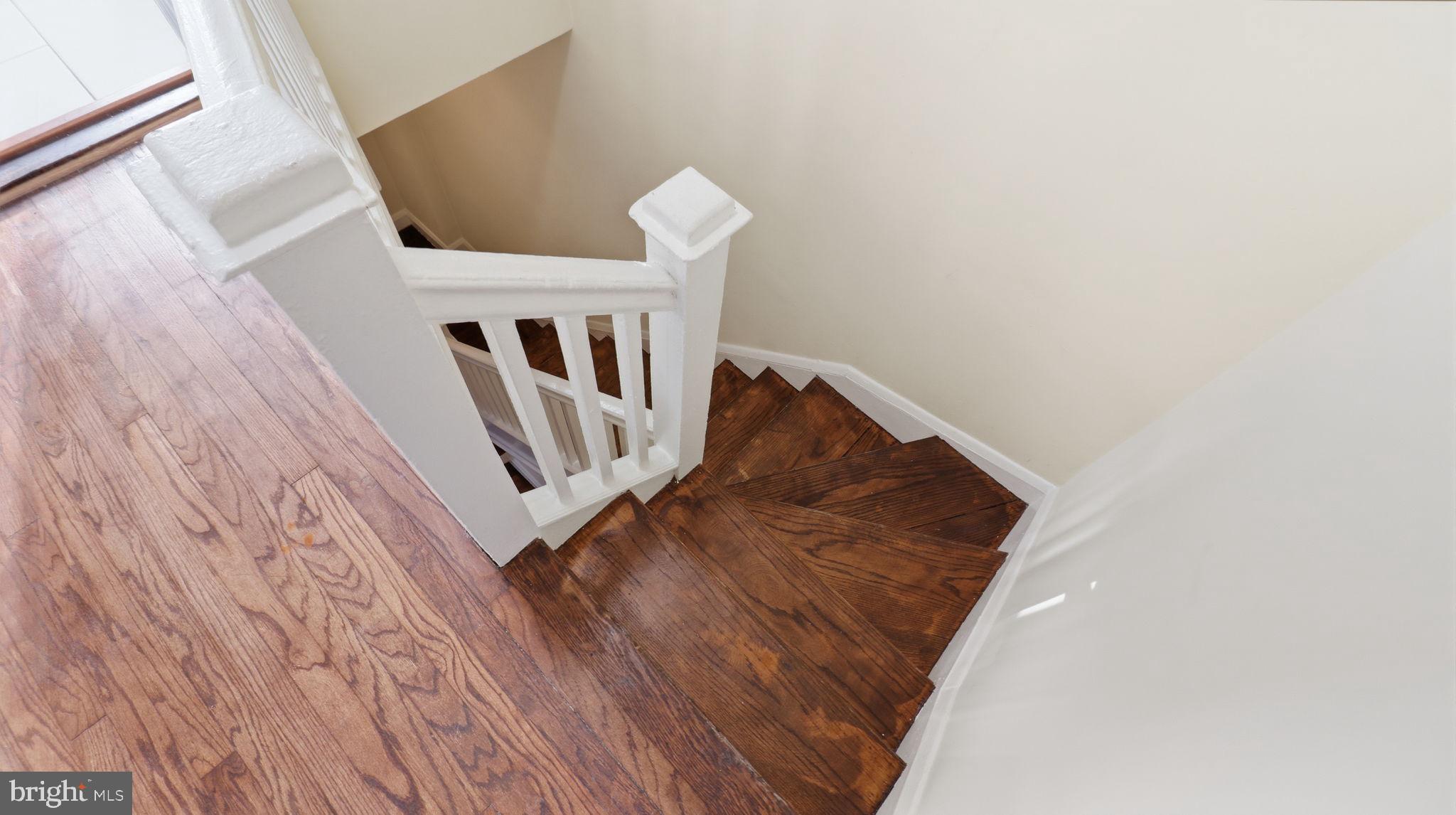 3324 Cliftmont Avenue Baltimore, MD 21213 - Photo 16 of 37 a view of stairs with wooden floor
