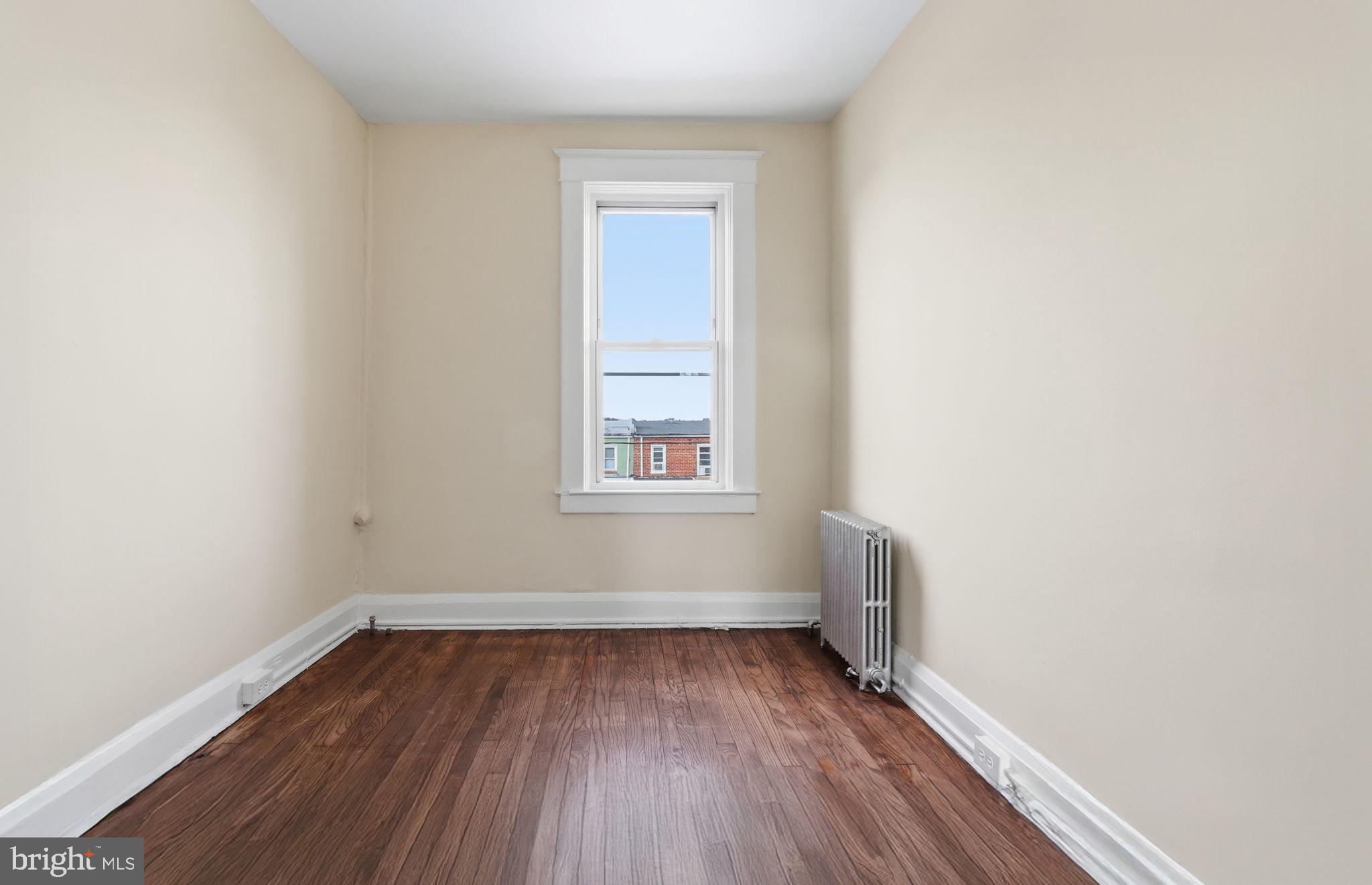 3324 Cliftmont Avenue Baltimore, MD 21213 - Photo 19 of 37 a view of a room with wooden floor and window