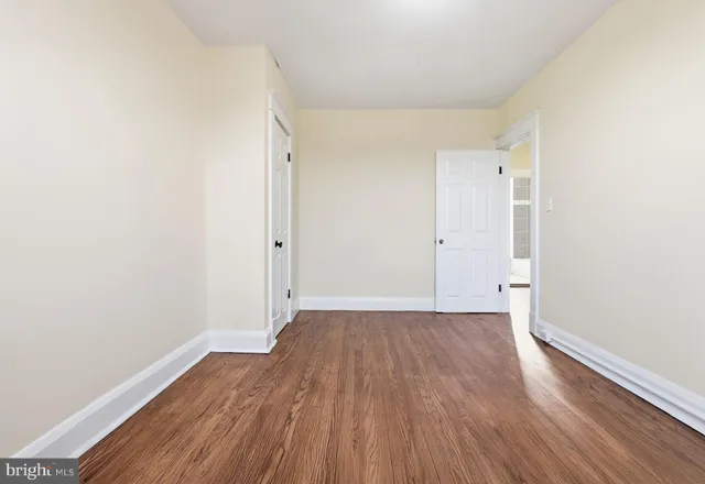 an empty room with wooden floor
