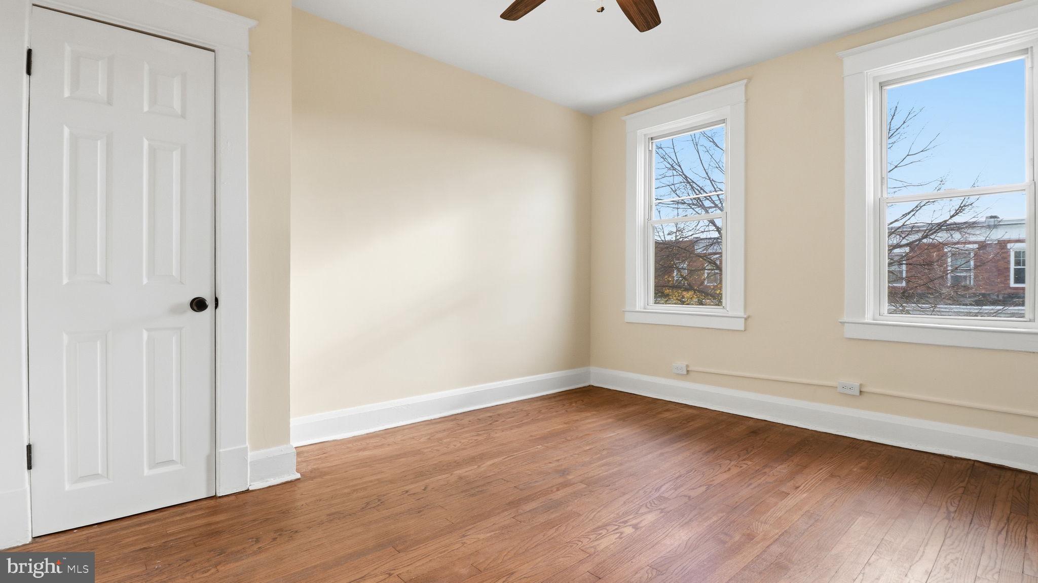 3324 Cliftmont Avenue Baltimore, MD 21213 - Photo 24 of 37 a view of an empty room with wooden floor and a window