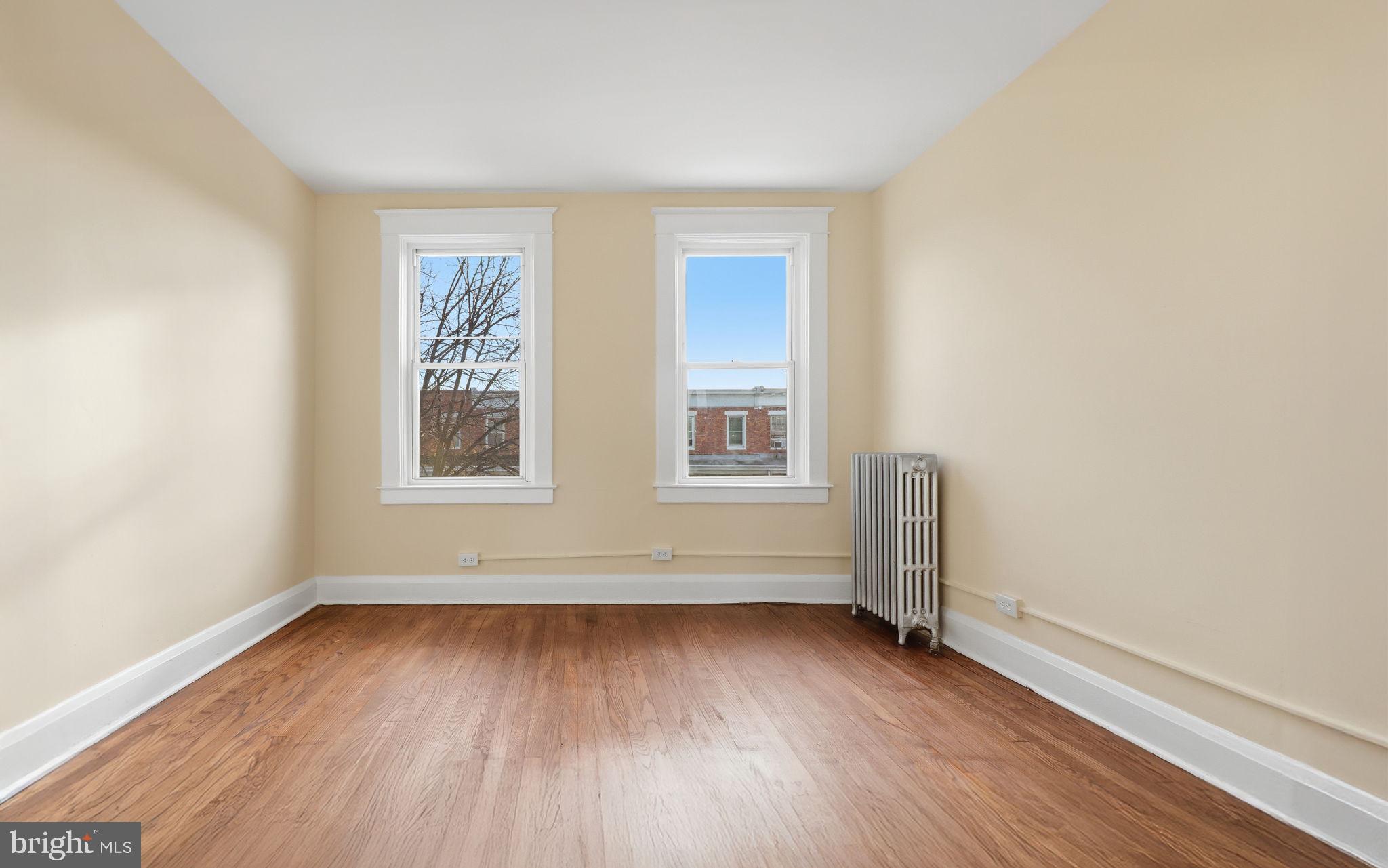 3324 Cliftmont Avenue Baltimore, MD 21213 - Photo 25 of 37 an empty room with wooden floor and windows