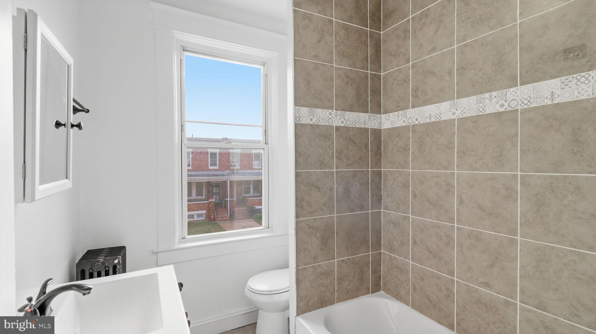3324 Cliftmont Avenue Baltimore, MD 21213 - Photo 28 of 37 a bathroom with a toilet and a shower