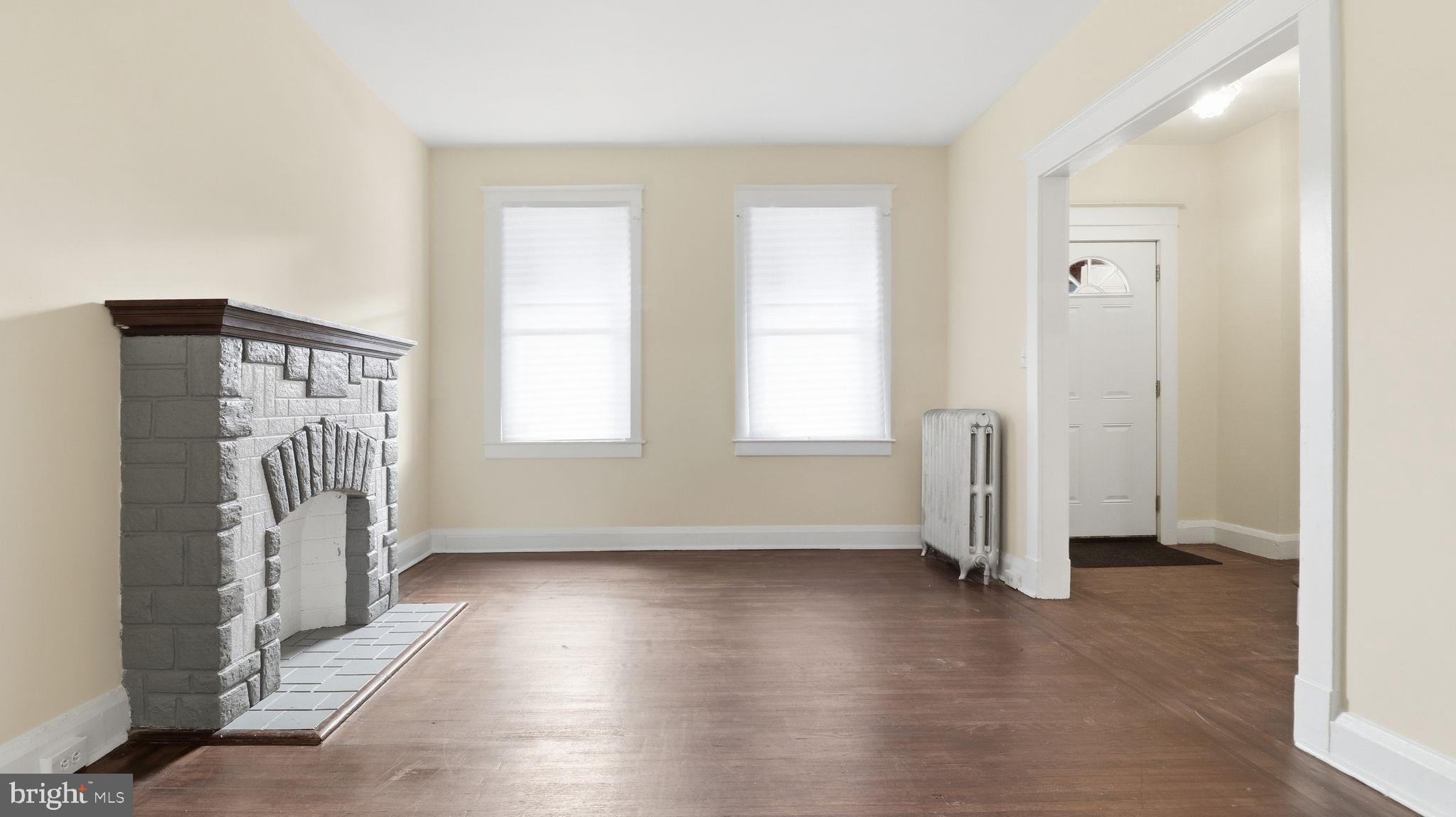 3324 Cliftmont Avenue Baltimore, MD 21213 - Photo 9 of 37 an empty room with wooden floor and a window