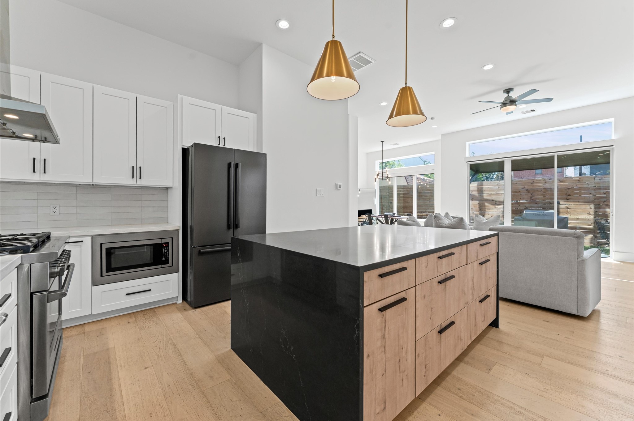 711 Lester Street Houston, TX 77007 - Photo 15 of 39 a kitchen with stainless steel appliances granite countertop a sink a stove a refrigerator a washer and dryer