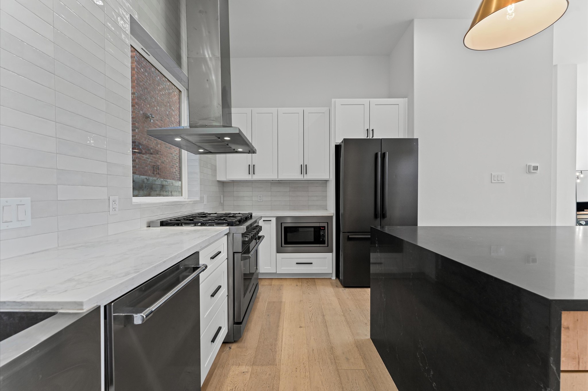 711 Lester Street Houston, TX 77007 - Photo 18 of 39 a kitchen with stainless steel appliances a sink stove and refrigerator