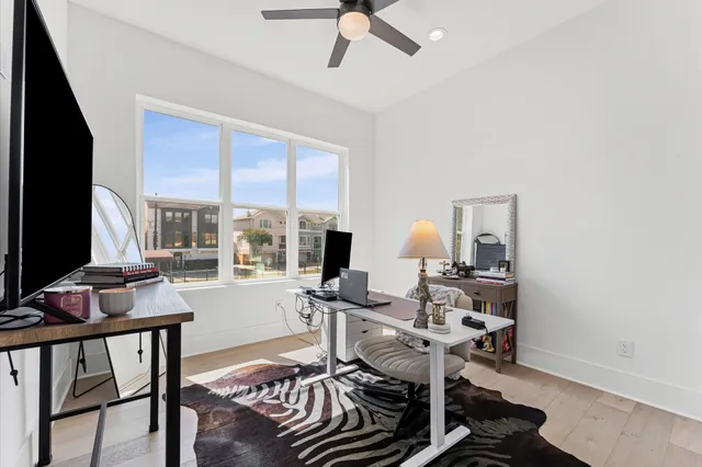 a spacious bedroom with a large bed and a large window