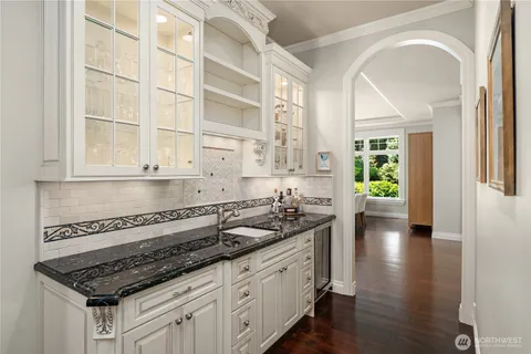 a kitchen with granite countertop a sink and cabinets