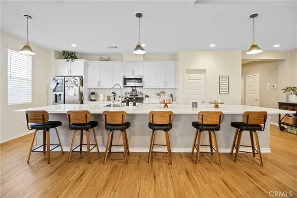 a large kitchen with lots of furniture and appliances