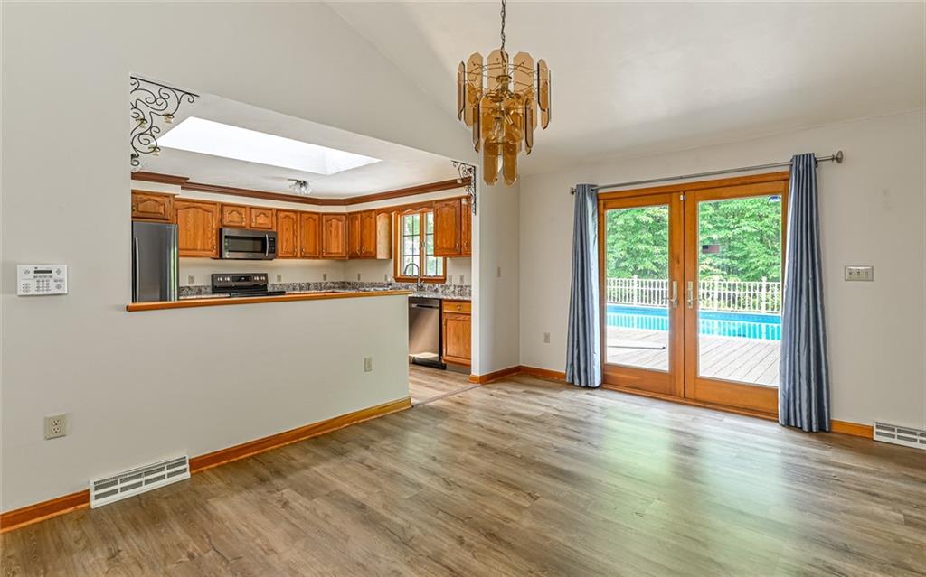 175 Dance Hall Road Apollo, PA 15613 - Photo 11 of 37 a kitchen with stainless steel appliances granite countertop a stove and a wooden floors