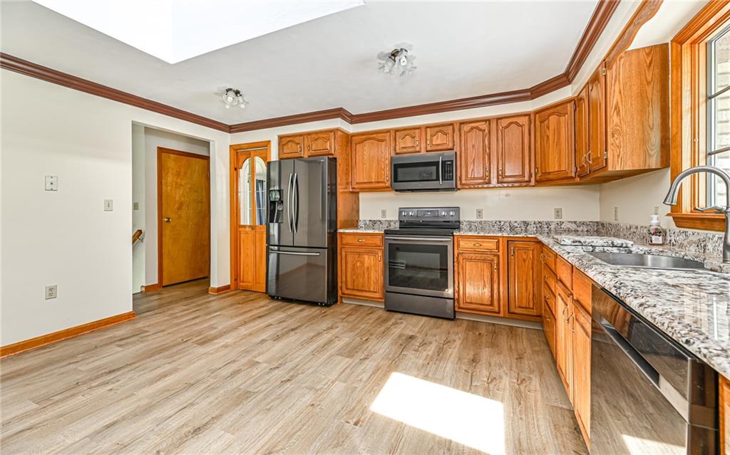 175 Dance Hall Road Apollo, PA 15613 - Photo 13 of 37 a kitchen with stainless steel appliances granite countertop a sink cabinets and wooden floor