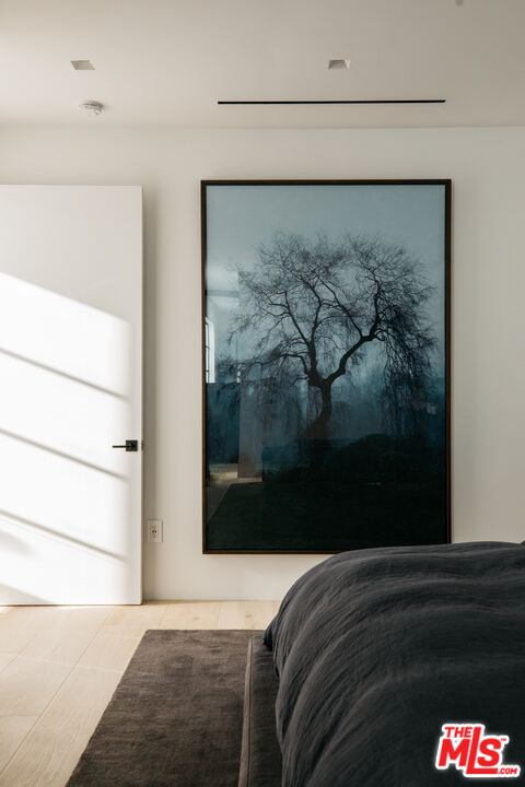 1346 Abbot Kinney Boulevard Venice, CA 90291 - Photo 9 of 18 a bedroom with a bed and a painting on the wall
